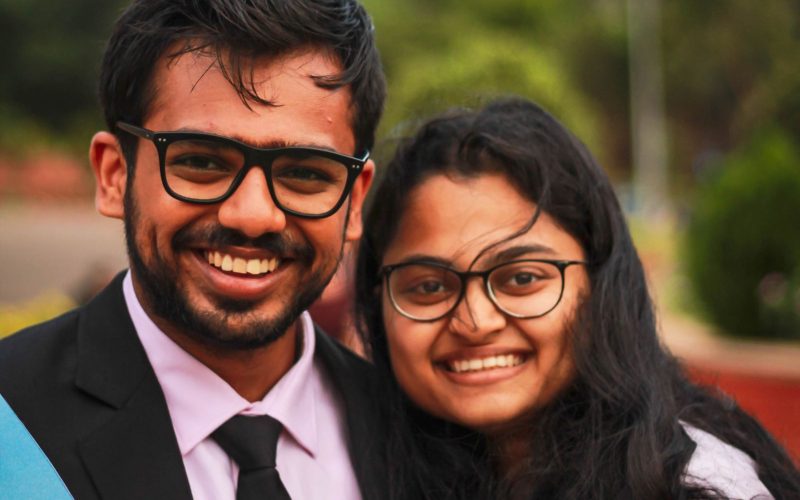 Two graduates celebrating after completing their programme